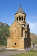 A church with ornate stone architecture against a clear blue sky, Noravank monastery, Surb