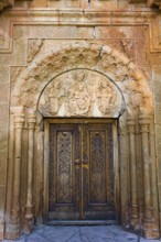 Elaborately carved wooden gate with beautiful stone decorations and architectural details, Noravank