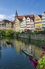 Historic houses on the Neckar front, the Neckar river with poking and water reflection, old town of