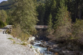 River Ruetz am Wilde Wasser Weg with hiking trail and bridge in autumn, WildeWasserweg, Stubai