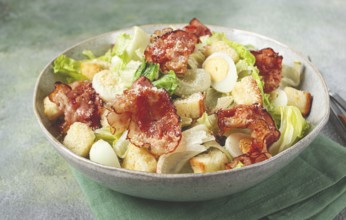 Caesar salad with fried bacon, quail eggs, homemade, no people