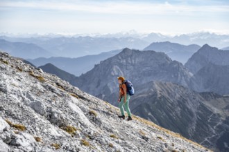 Female hiker on steep rocky slope, hiking to Gamsjoch, eastern Karwendel, Tyrol, Austria