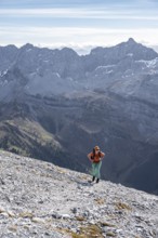 Female hiker on steep rocky slope, hiking to Gamsjoch, eastern Karwendel, Tyrol, Austria