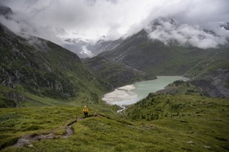 Hikers in a cloudy mountain landscape, Margaritzen Reservoir, Grossglockner High Alpine Road, Hohe