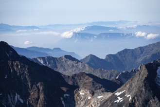 Rocky mountain landscape with snow-capped peaks and clear views, Hohe Tauern National Park,