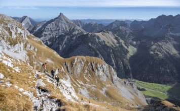 Hiker on a rocky mountain trail with a wide view of the valley, eastern Karwendel, Tyrol, Austria