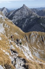 Hiker on a steep trail with impressive mountain scenery, eastern Karwendel, Tyrol, Austria