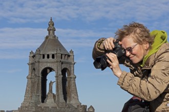 Woman photographing model, Kaiser Wilhelm Memorial, Porta Westfalica, North Rhine-Westphalia,