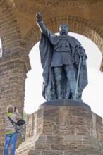 Woman photographing statue, Kaiser Wilhelm Memorial, Porta Westfalica, North Rhine-Westphalia,