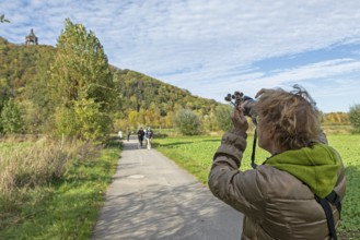 Woman photographing Kaiser Wilhelm monument, mountain, forest, path, Porta Westfalica, North