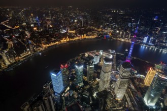 Aerial view over The Bund, Huangpu River and Lujiazui financial district with illuminated