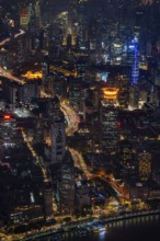 Aerial view over The Bund, Huangpu River waterfront and illuminated skyscrapers from the Shanghai