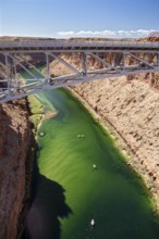 Marble Canyon, Arizona - Dories float under the Navajo Bridge which spans the Colorado River in