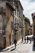 Alley, walkers, houses, shades of orange, Arles, France
