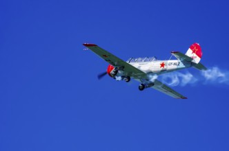 A Jakovlev Jak-52 with registration LY-HLZ during a flight demonstration as part of an air show on