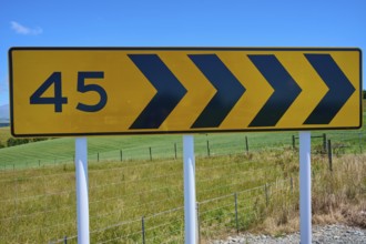 Road sign with arrows and number 45 in front of green landscape, Geraldine Fairlie Lookout,