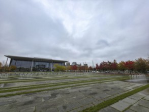 Extensive square with water fountains in the government district under heavy cloud cover in the