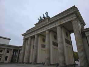 The Brandenburg Gate, landmark of the city of Berlin, in front of cloudy skies, government district