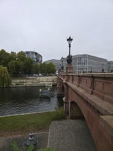 The Moltke Bridge, historic bridge across the Spree with wrought-iron chandelier, flanked by modern