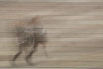 Abstract of a woman walkig up stone steps captured using ICM intentional camera movement technique,