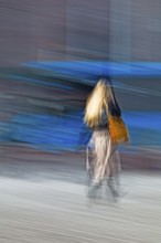 Abstract of a woman walking in front of a bus captured using ICM intentional camera movement