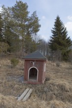 Old fashioned milk pier next to the road in cloudy spring weather, Junkarsborg, Finland