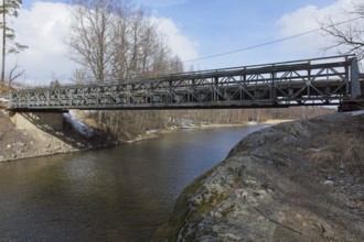 Metal bridge over river Mustionjoki in winter, Junkarsborg, Finland