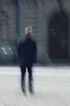 Abstract of a man walking with cruthces captured using ICM intentional camera movement technique,