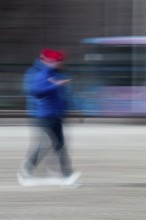 Abstract of a man walking and looking at his phone captured using ICM intentional camera movement