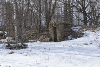 Old abandoned brick cellar under the ground in winter, Junkarsborg, Finland