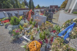 Cemetery with fresh graves in Maria-Thann, Allgäu, Swabia, Bavaria, Germany
