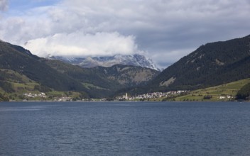The town of Reschen on Lake Reschen in Italy is surrounded by impressive mountains