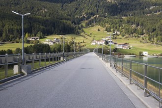 There is a narrow road on the dam that dams Lake Reschen in South Tyrol in Italy