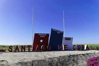 Blue sky sign 'Santiago de Cuba' in front of the countryside, Cuba, Greater Antilles, Caribbean,