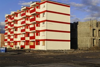 Baracoa, Cuba, Central America, modern high-rise building with eye-catching red and white color