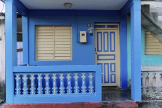Baracoa, Cuba, Central America, Blue House with pastel colored doors, modern balcony and closed