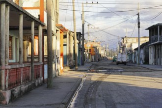 Baracoa, Cuba, Central America, Deserted street with empty sidewalks and visible old buildings,