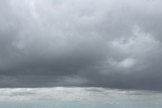 Large cloud field in front closed cloud cover from low-hanging low-hanging Nimbostratus gray
