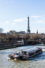 Tourist boat on Seine River viewed from Pont Alexandre III (Alexandre III Bridge) and Eiffel Tower
