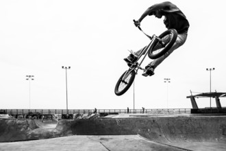 Young man jumping with a bicycle at Skatepark, in Playa Brava. Iquique, Tarapaca Region, Chile. 16