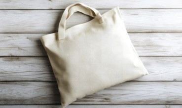 A white bag with a handle sits on a wooden surface. The bag is empty and has a simple design.
