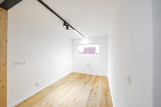 Light small room with oak floor and window, ready for furnishing and use, house renovation, energy