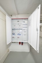 Open electrical distributor in a clean cellar room, modern and well-arranged, house renovation,
