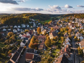 A village with church and colorful autumn trees under a blue sky, Deufringen, Aidlingen, Böblingen