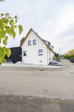 Gable view of a semi-detached house on a quiet residential street with minimalistic design, house