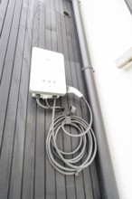 Charging station for electric cars on dark exterior, house renovation, climate renovation,