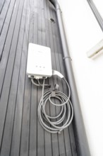 White wallbox on black wooden façade, house renovation, climate renovation, Metzingen, Germany