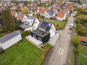 Overview of a quiet residential area with modernized house with solar system and dark extension on