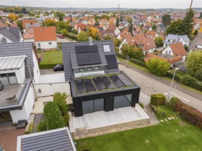 Aerial view of a house with solar system in a quiet residential area, house renovation, climate