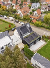 Top view shows PV modules and covered terrace at a modern extension with large wooden deck and